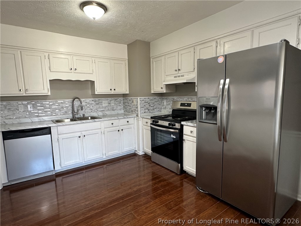 2678 Rivercliff Road Fayetteville, NC 28301 - Photo 7 of 19 a kitchen with a refrigerator sink and cabinets