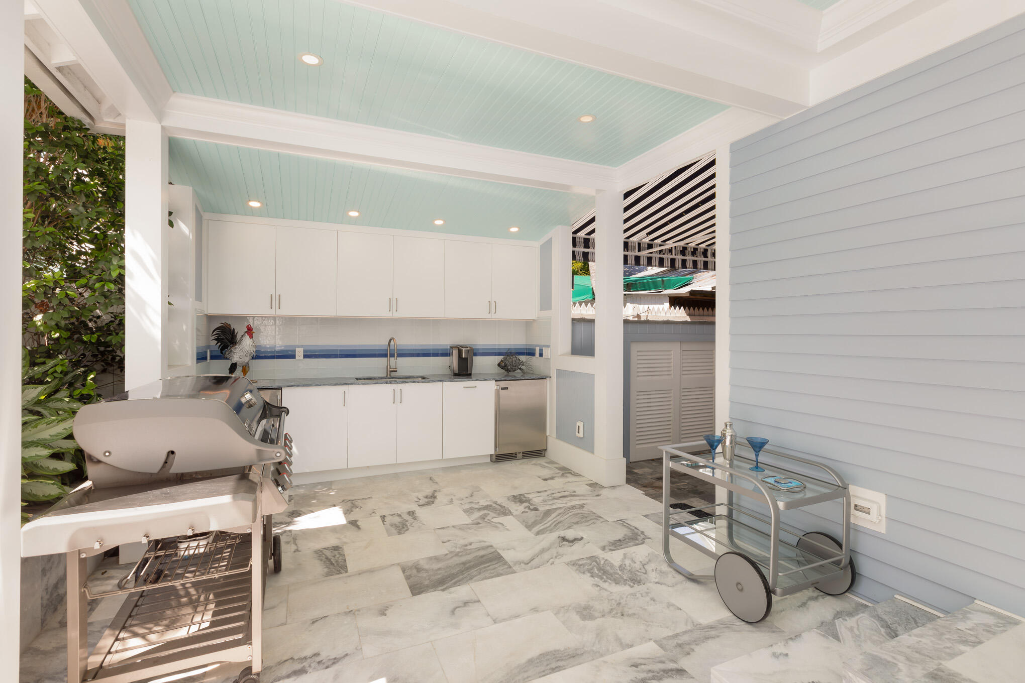 626 William Street Key West, FL 33040 - Photo 49 of 68 a kitchen with a sink and white cabinets