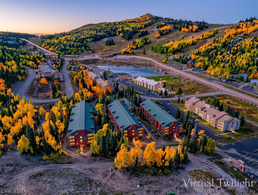 407 South Vasels Road, Unit 49 Brian Head, UT 84719 - Photo 34 of 45 A picturesque mountain community nestled among vibrant autumn forests with scenic lake views.