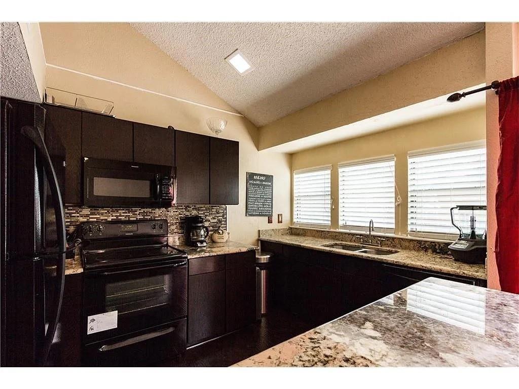 519 Ranch Trail, Unit 134 Irving, TX 75063 - Photo 13 of 20 a kitchen with a sink stove and microwave