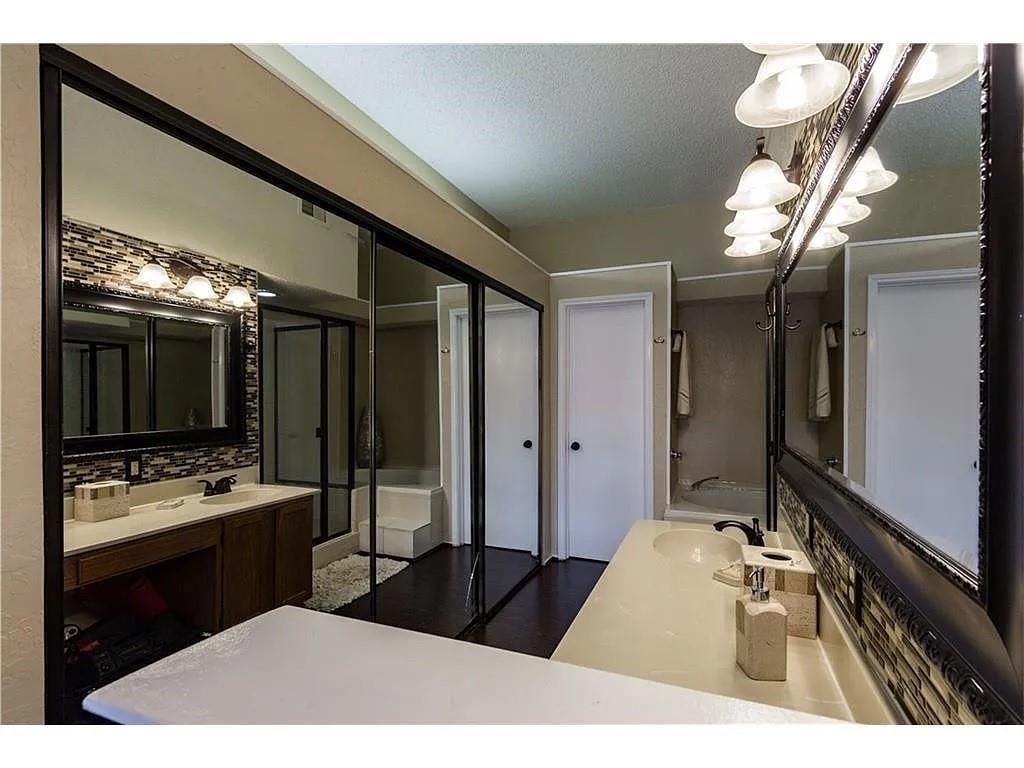 519 Ranch Trail, Unit 134 Irving, TX 75063 - Photo 18 of 20 a bedroom with a bed and a large mirror