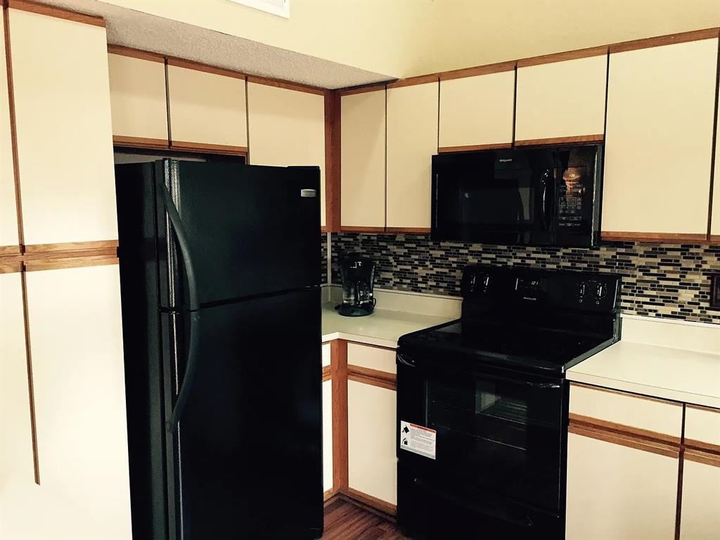 519 Ranch Trail, Unit 134 Irving, TX 75063 - Photo 3 of 20 a kitchen with a refrigerator and a sink