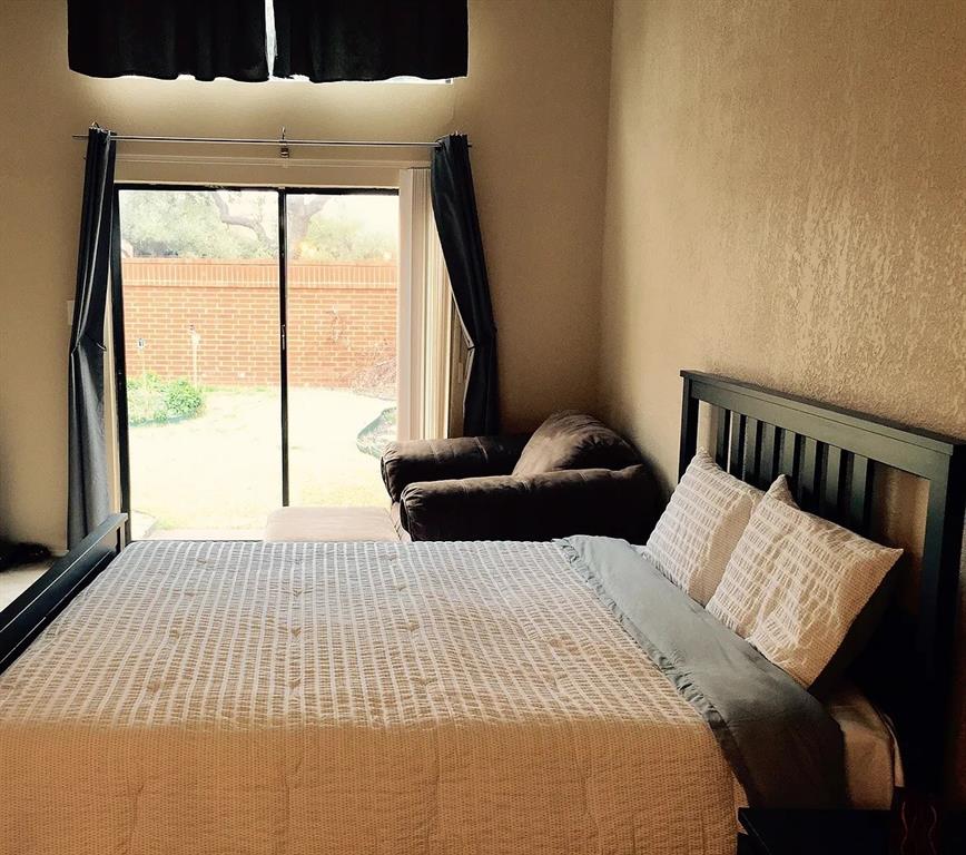 519 Ranch Trail, Unit 134 Irving, TX 75063 - Photo 4 of 20 a bedroom with a large bed and a large window