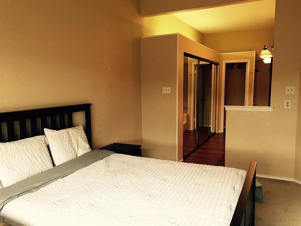 519 Ranch Trail, Unit 134 Irving, TX 75063 - Photo 5 of 20 a bedroom with a bed and a dresser