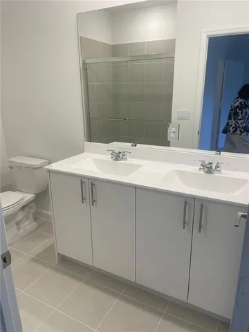 a bathroom with a sink toilet and mirror