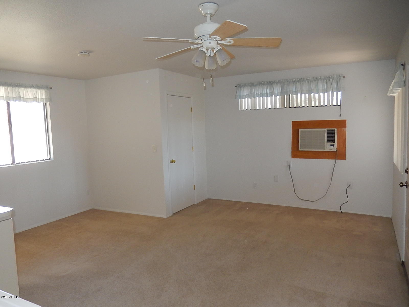 2951 East Bloomfield Road Phoenix, AZ 85032 - Photo 23 of 44 an empty room with windows and fan