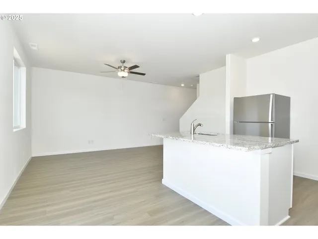 a view of a kitchen with a sink and a refrigerator