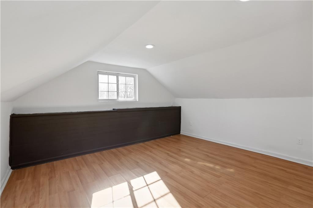 1512 Flat Shoals Road Atlanta, GA 30349 - Photo 14 of 35 an empty room with wooden floor and windows