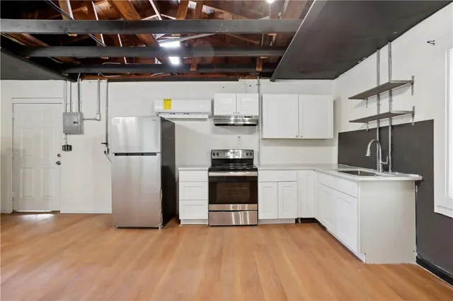 a kitchen with stainless steel appliances a refrigerator and a stove top oven