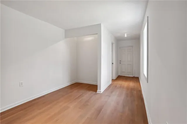 an empty room with wooden floor