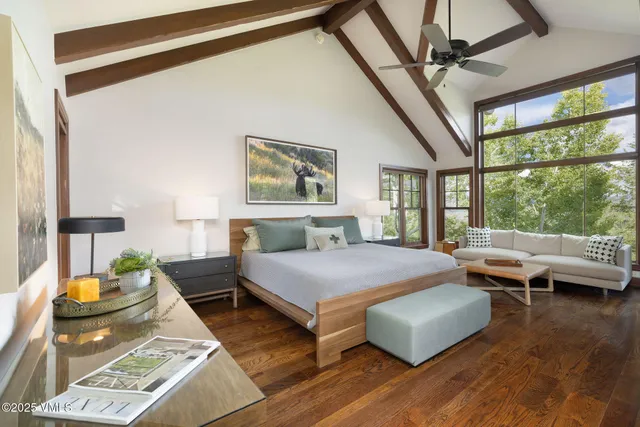 a bedroom with furniture and a large window