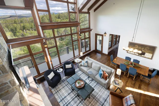 a living room with furniture and a floor to ceiling window