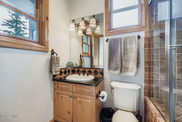 a bathroom with a sink mirror vanity and toilet