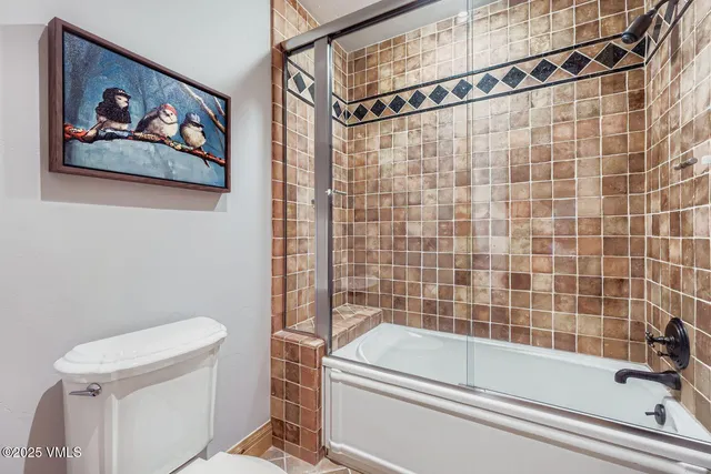 a bathroom with a toilet a sink and bathtub