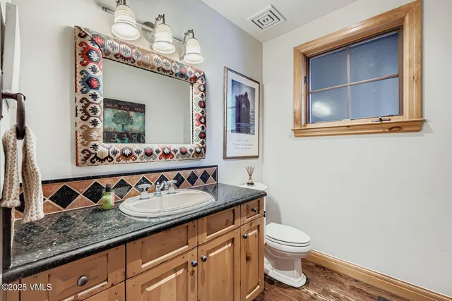 a bathroom with a sink a mirror and a toilet