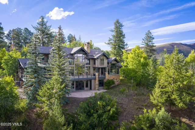 a view of a house with a yard and sitting area