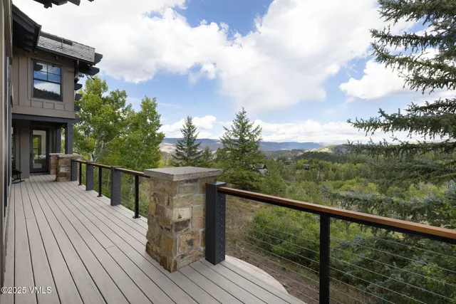 a balcony with wooden floor and city view
