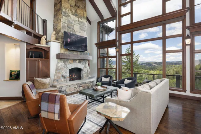 a living room with furniture fireplace and a floor to ceiling window