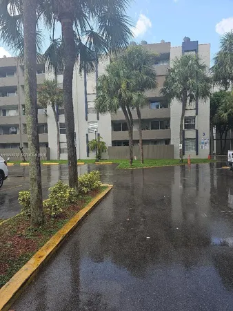 a view of a street with large trees