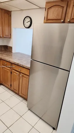 a view of a refrigerator in kitchen and wooden floor