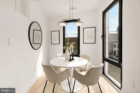 a dining room with furniture and a window