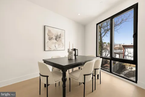 a view of a dining room with furniture and a large window