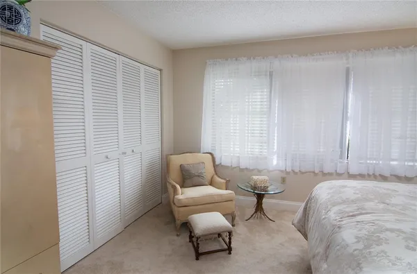 a spacious bedroom with a bed and a window