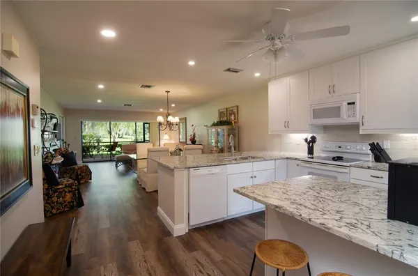 a kitchen with counter top space cabinets and appliances