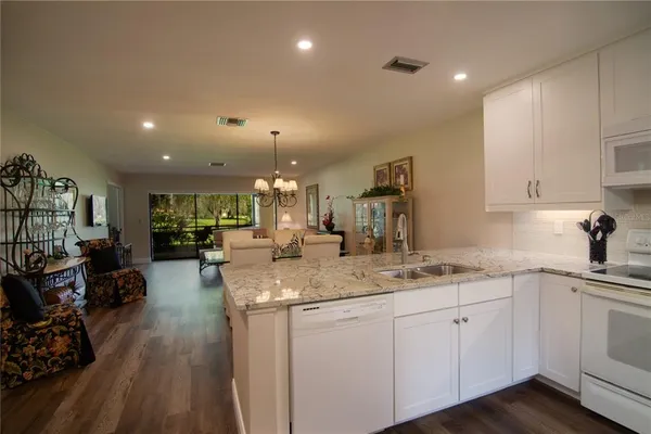 a kitchen with sink stove and cabinets