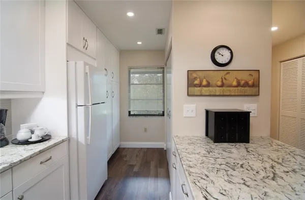 a hallway with a fireplace and wooden floor