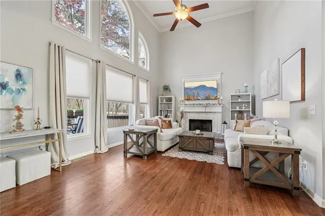 a living room with furniture fireplace and wooden floor