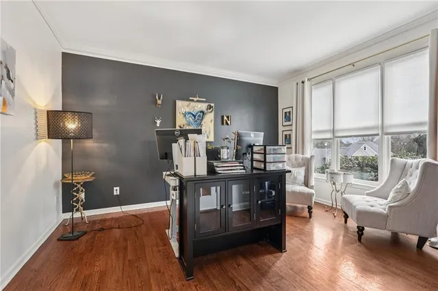 a view of a workspace with wooden floor