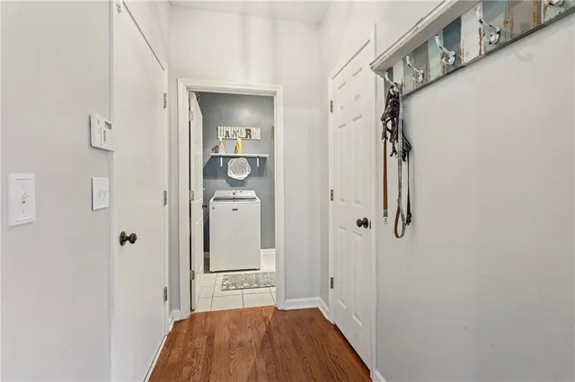 a view of a hallway with wooden floor and staircase