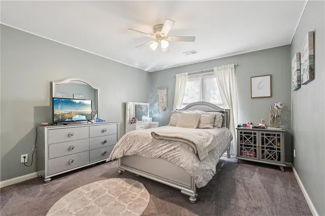 a bedroom with a bed and a dresser in it