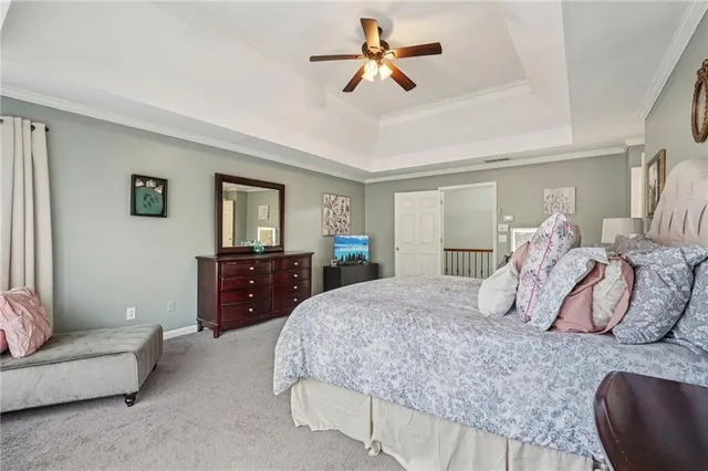 a bedroom with a large bed and a couch