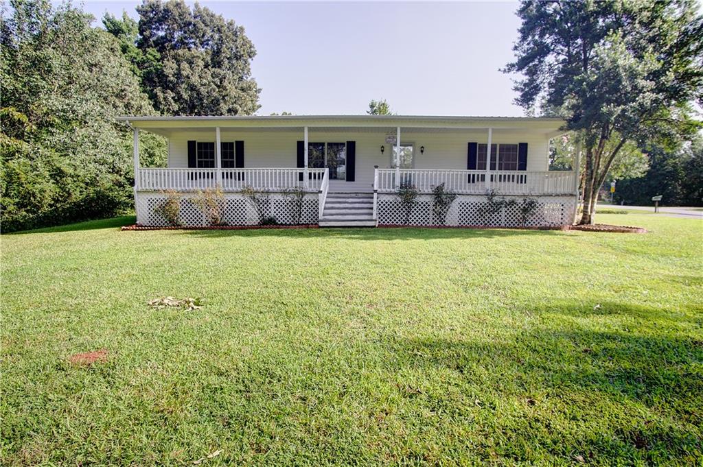 a front view of house with yard and seating area