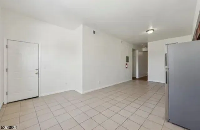 a view of an empty room with glass door