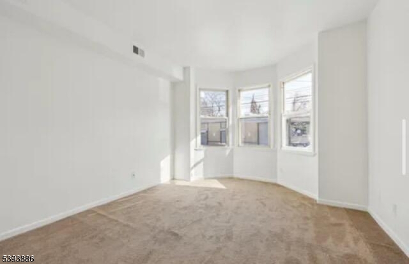 235 South 11th Street, Unit 3 Newark, NJ 07107 - Photo 8 of 11 a view of an empty room with glass door