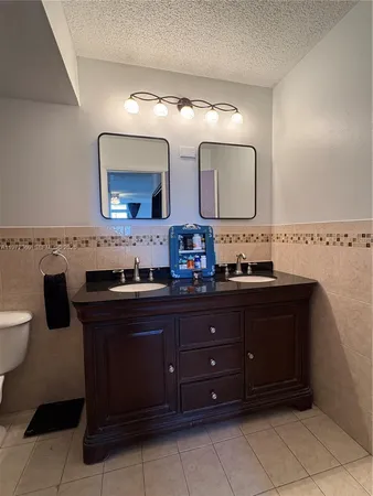 a bathroom with a toilet and a mirror