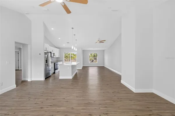 a view of an empty room with wooden floor