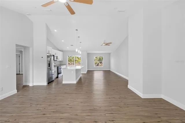 a view of an empty room with wooden floor