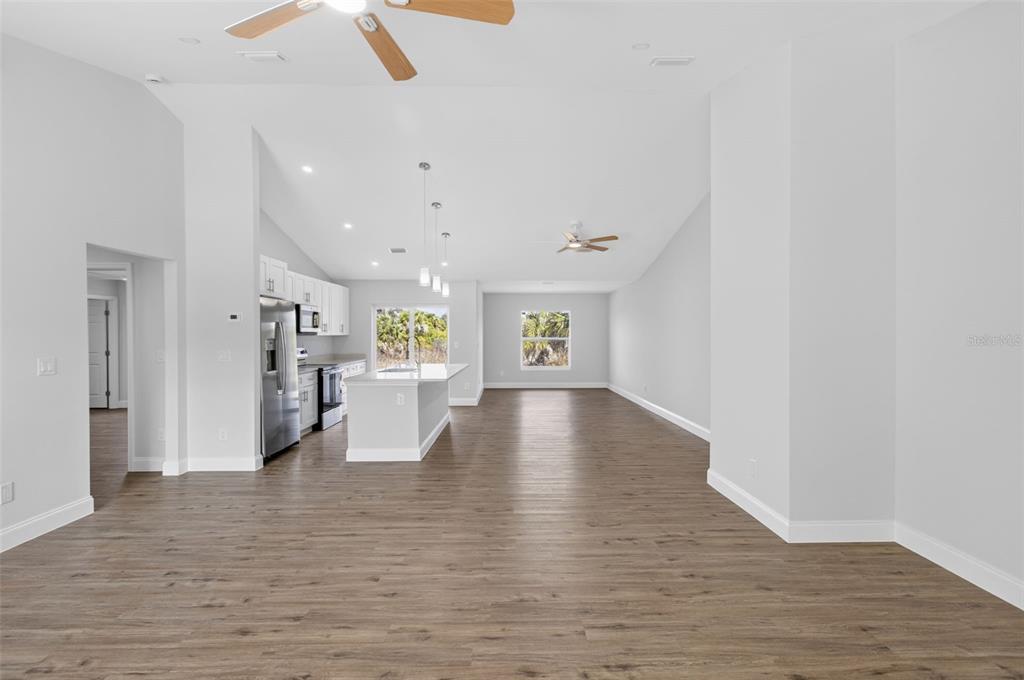 375 Denver Drive Port Charlotte, FL 33954 - Photo 13 of 37 a view of an empty room with wooden floor
