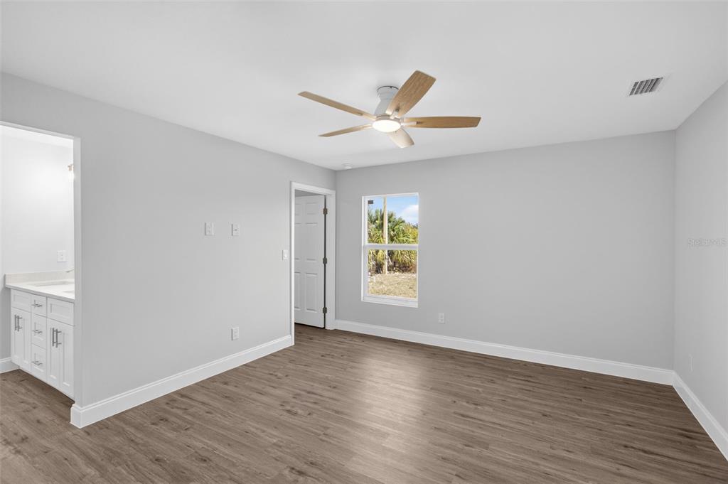 375 Denver Drive Port Charlotte, FL 33954 - Photo 14 of 37 an empty room with wooden floor and windows