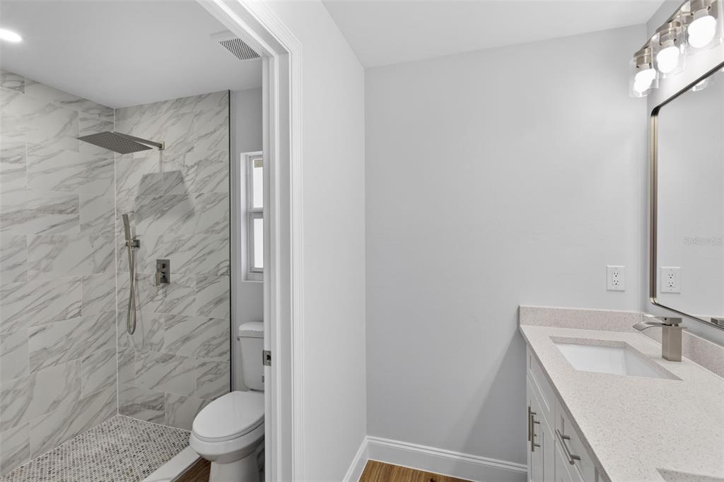 375 Denver Drive Port Charlotte, FL 33954 - Photo 18 of 37 a bathroom with a granite countertop sink toilet and shower