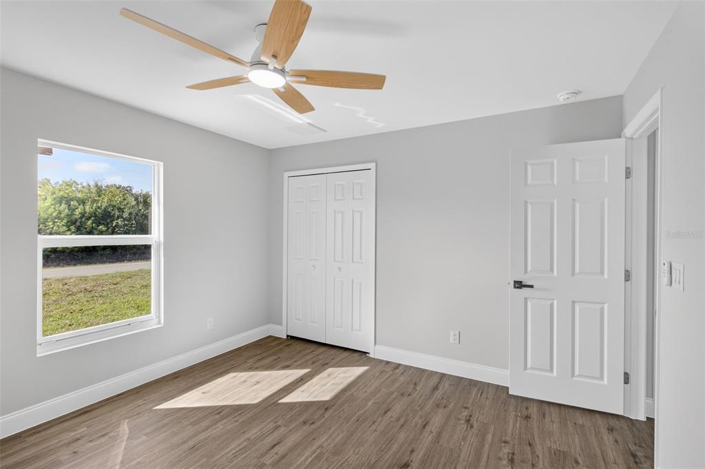 375 Denver Drive Port Charlotte, FL 33954 - Photo 25 of 37 wooden floor in an empty room with a window