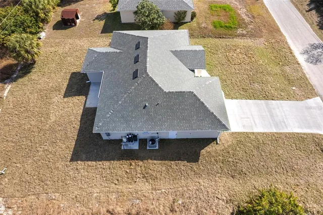 an aerial view of a house with a yard