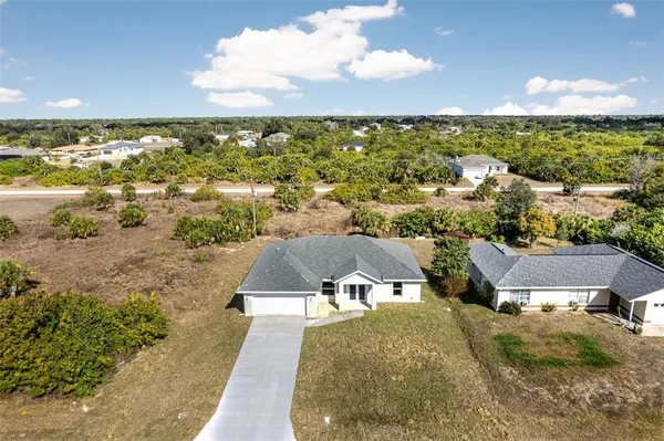 an aerial view of residential houses with outdoor space