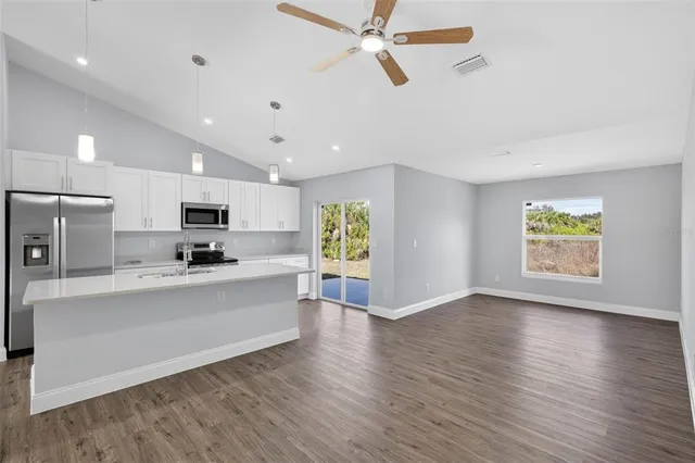 a view of a kitchen with microwave and cabinets