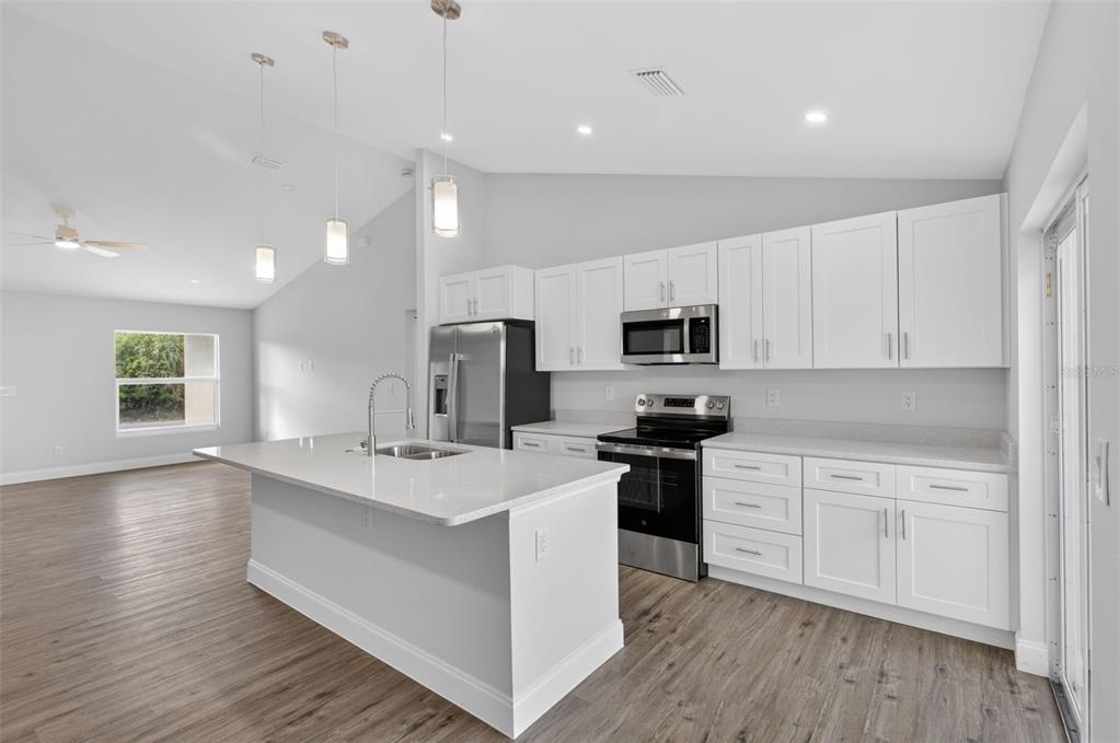 375 Denver Drive Port Charlotte, FL 33954 - Photo 6 of 37 a kitchen with stainless steel appliances a sink stove and microwave