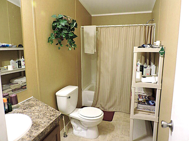 915 North 5000 W Road Hinckley, UT 84635 - Photo 14 of 27 Bathroom featuring a tub/shower combination, toilet, and vanity with a laminate countertop and integrated sink